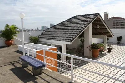 Charming rooftop terrace with city views and cozy seating area, perfect for relaxation and gatherings.