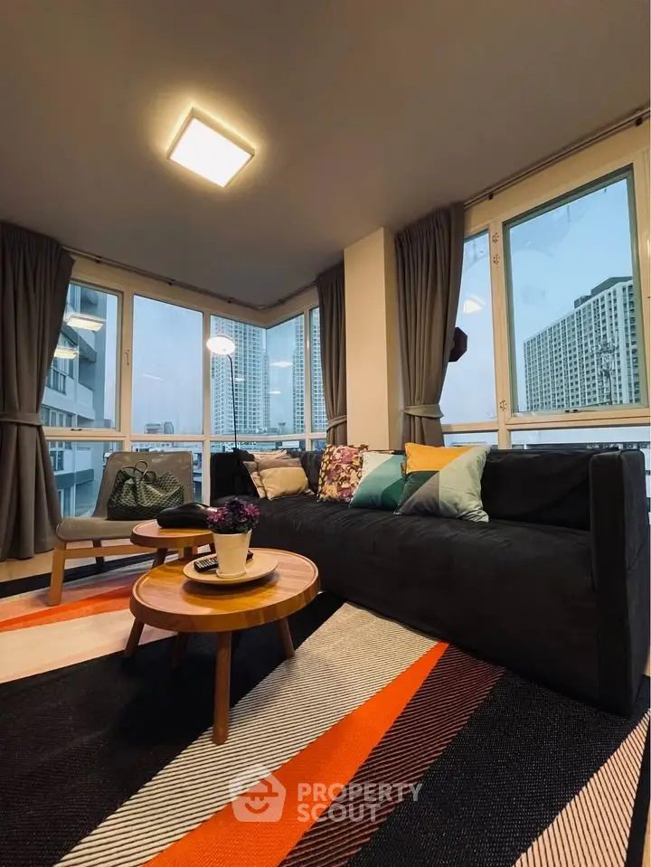 Stylish modern living room with panoramic city views and chic decor.