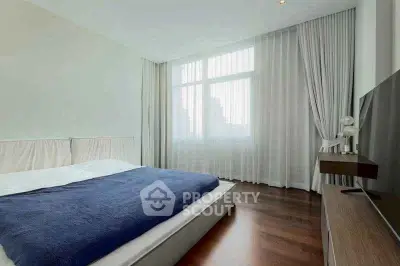 Spacious modern bedroom with large window and elegant decor