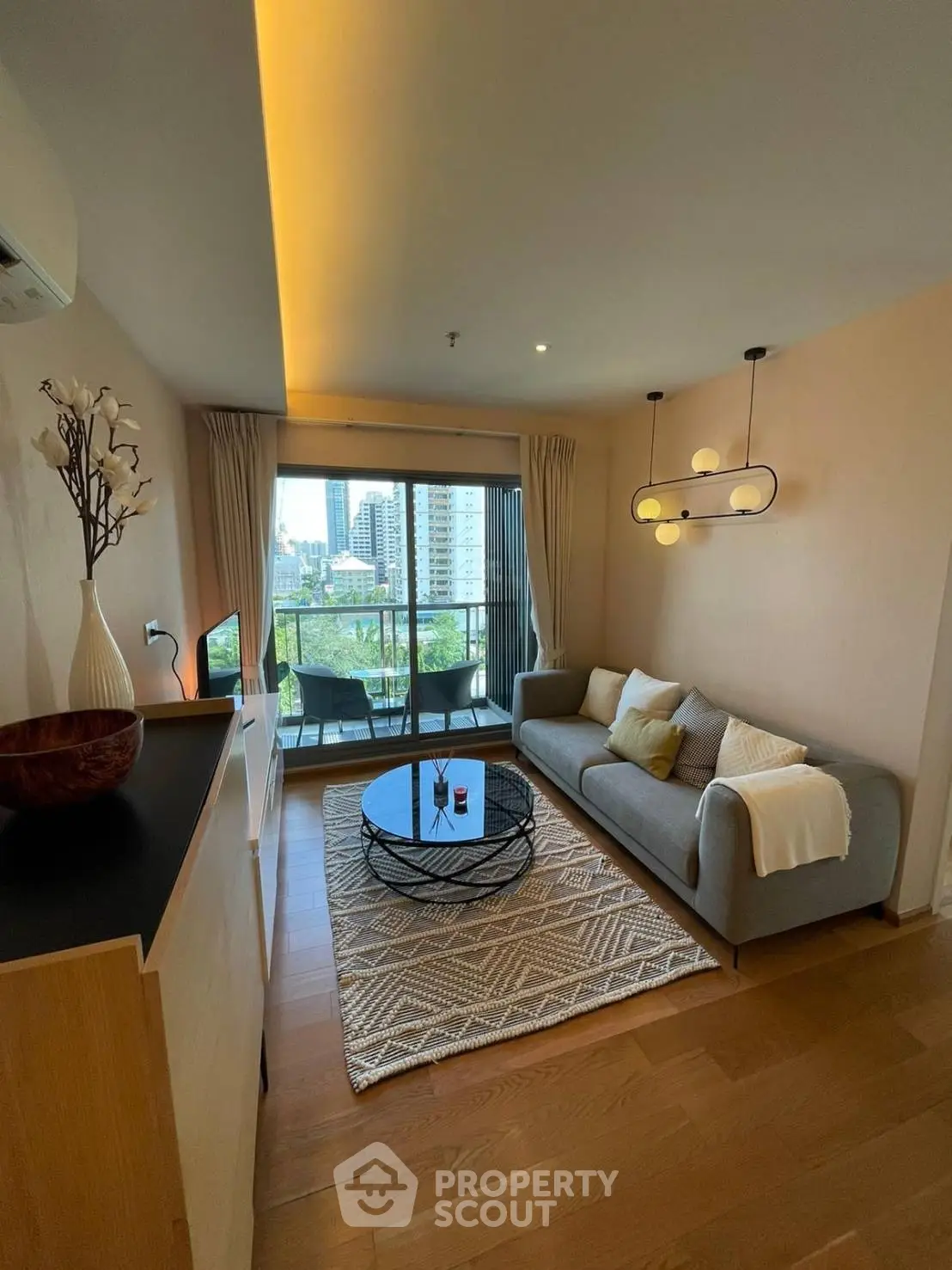 Modern living room with stylish decor and city view balcony