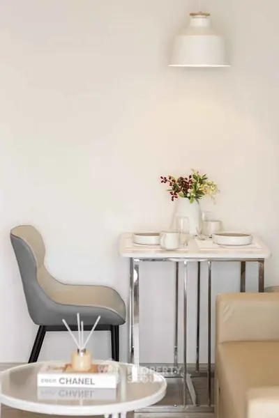 Stylish modern dining nook with elegant decor and cozy seating in a contemporary apartment.