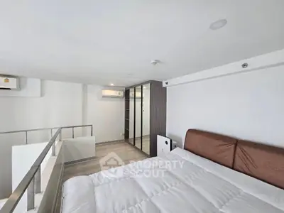 Modern loft bedroom with sleek design and ample natural light