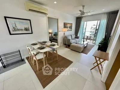 Spacious living room with modern decor and balcony access in a stylish apartment.