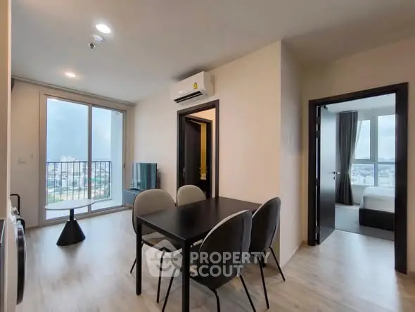 Modern apartment interior with dining area and bedroom view