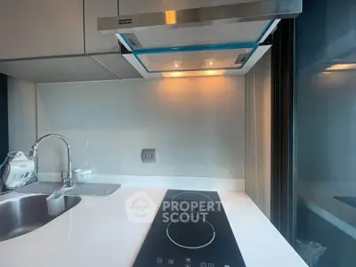 Modern kitchen with sleek induction cooktop and stylish range hood