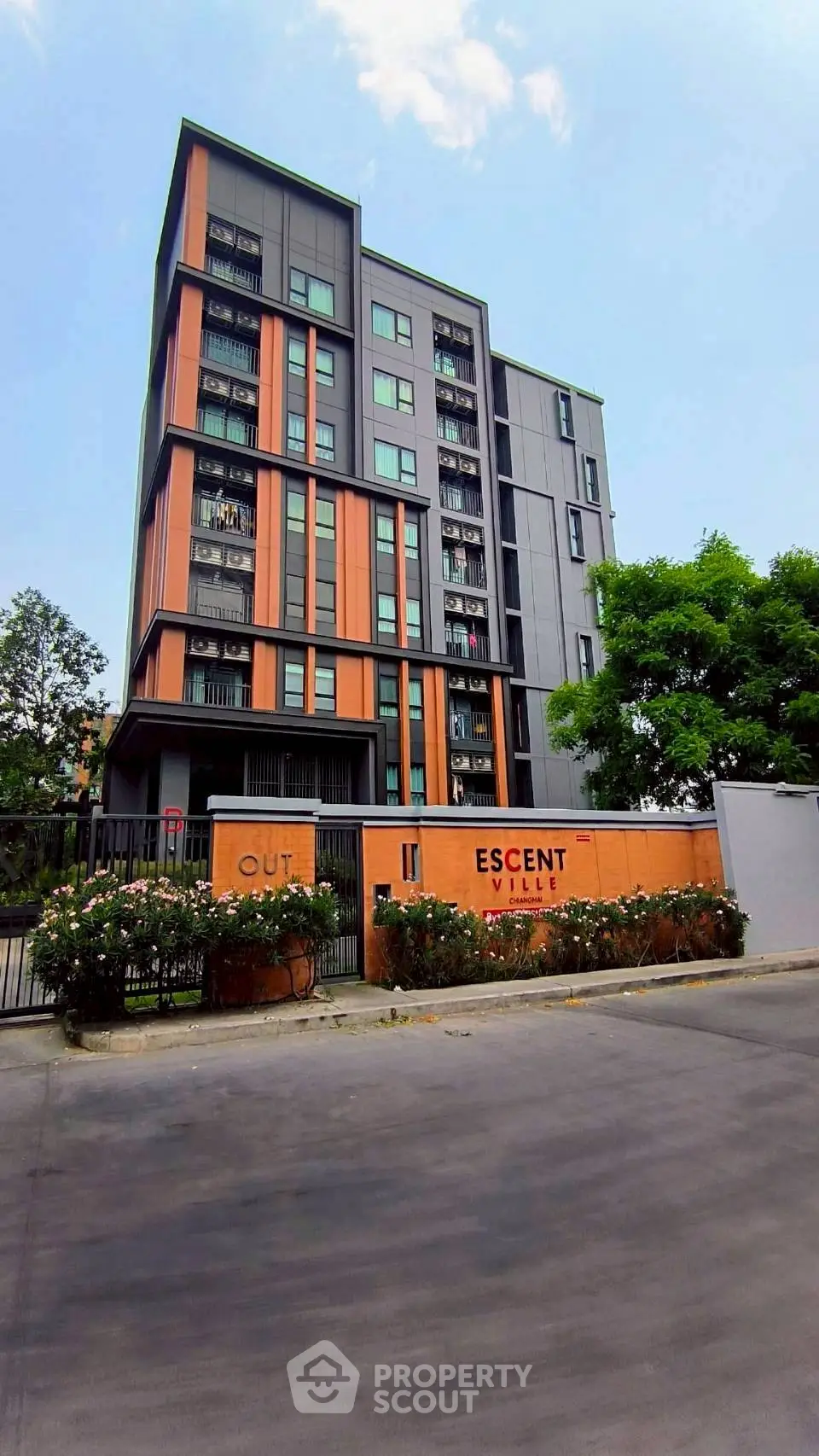 Modern apartment building with vibrant facade and lush greenery, ideal for urban living.