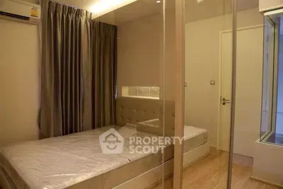 Modern bedroom with glass partition and elegant decor in a stylish apartment.