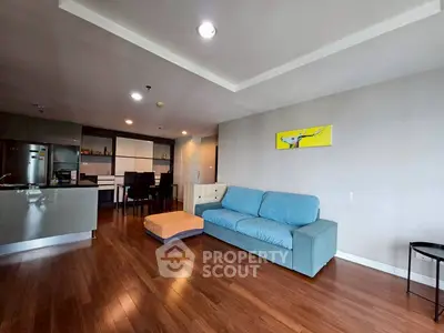 Spacious modern living room with hardwood floors and stylish furniture in open layout.