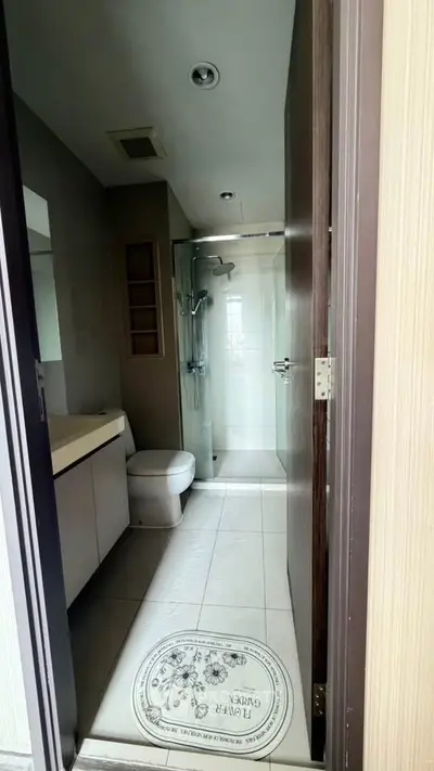 Modern bathroom with glass shower and sleek fixtures in a contemporary apartment.