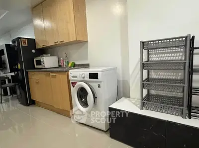Modern kitchen with washing machine and ample storage space
