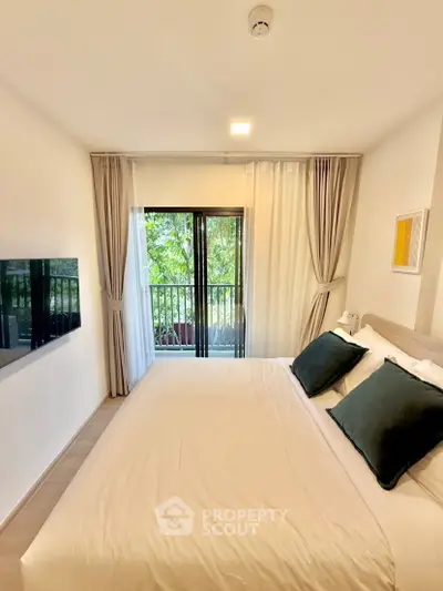Cozy bedroom with balcony view and modern decor in a serene setting.