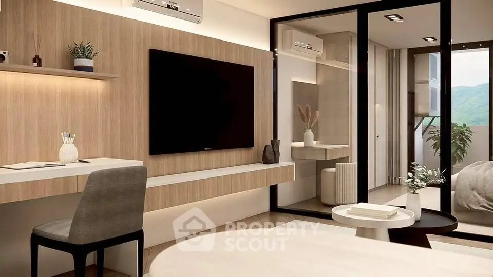 Modern living room with stylish decor and large TV, featuring a cozy workspace and balcony view.