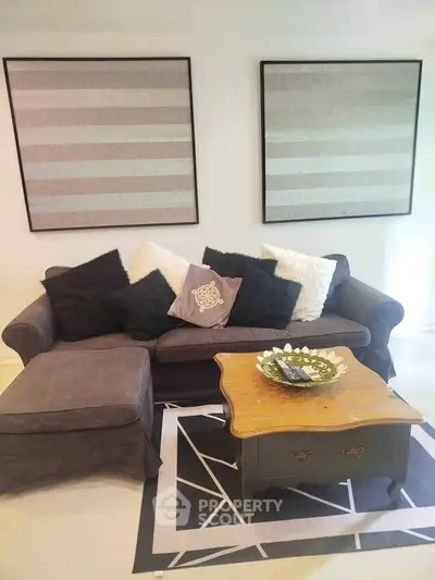 Chic living room with stylish sofa, modern art, and elegant coffee table for a cozy ambiance.