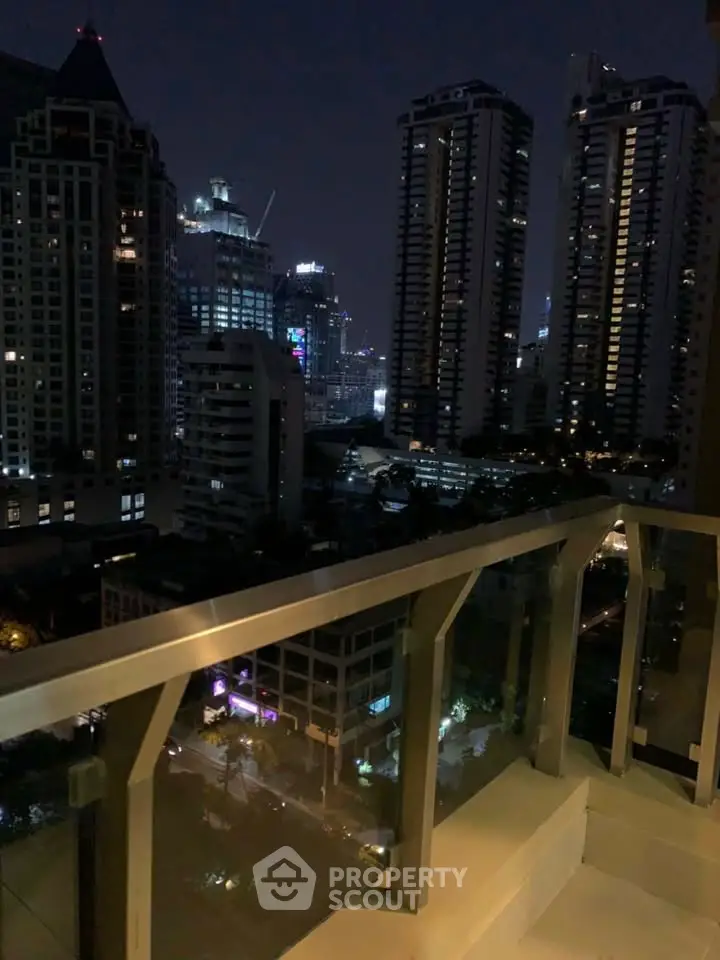 Stunning night city view from a modern balcony in a high-rise building.