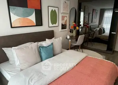 Stylish bedroom with modern decor and cozy bedding in a contemporary apartment.