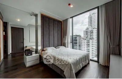 Luxurious bedroom with floor-to-ceiling windows offering stunning city views in a modern high-rise apartment.