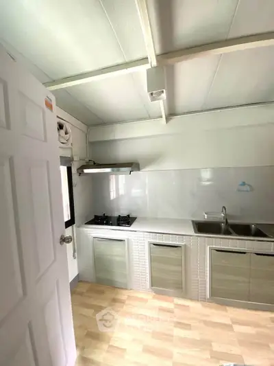 Modern kitchen with gas stove and sleek cabinetry in a cozy home.