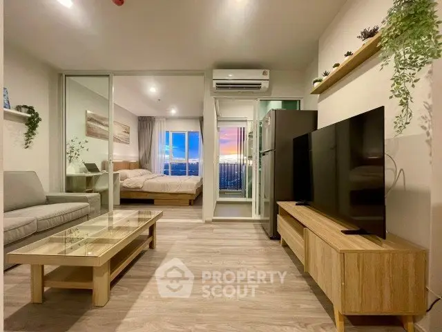 Modern open-plan living room with stylish decor and sunset view from the bedroom.