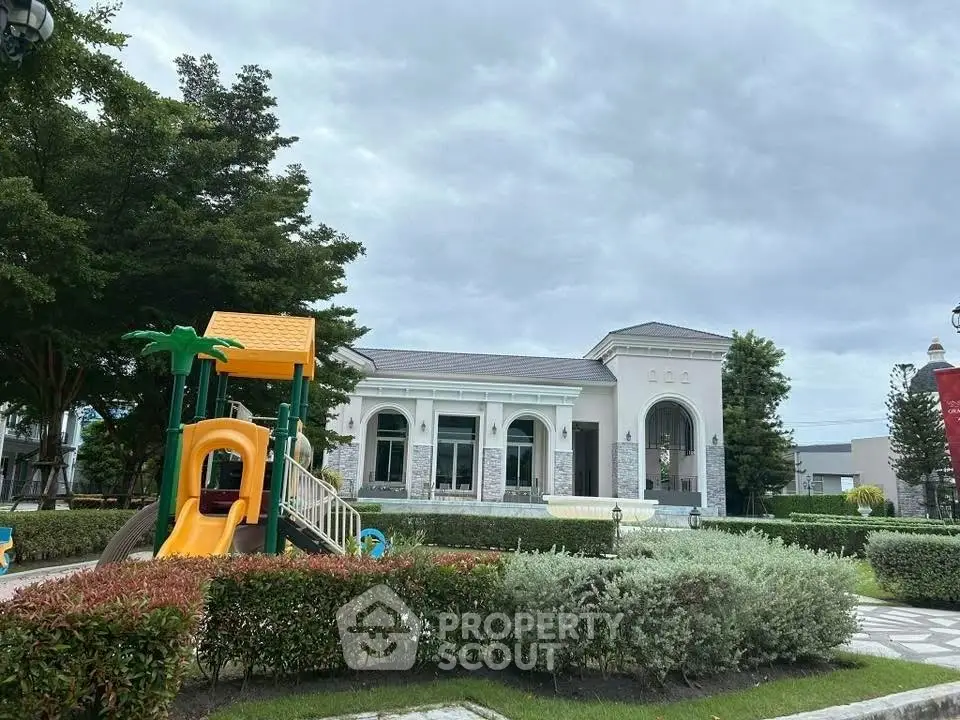 Charming residential building with lush garden and children's playground, perfect for family living.