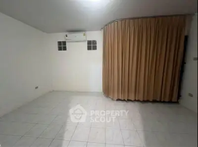Spacious unfurnished room with tiled flooring and air conditioning, ideal for customization.