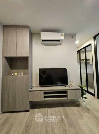 Modern living room with sleek TV unit and air conditioning