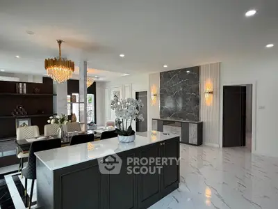 Luxurious open-plan living room with elegant decor and modern lighting