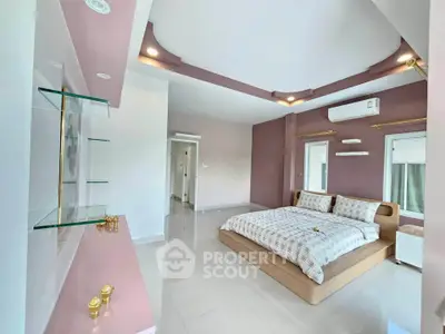 Spacious modern bedroom with elegant decor and ample natural light