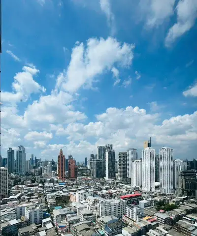 Stunning cityscape view showcasing modern skyscrapers under a vibrant blue sky, perfect for urban living enthusiasts.
