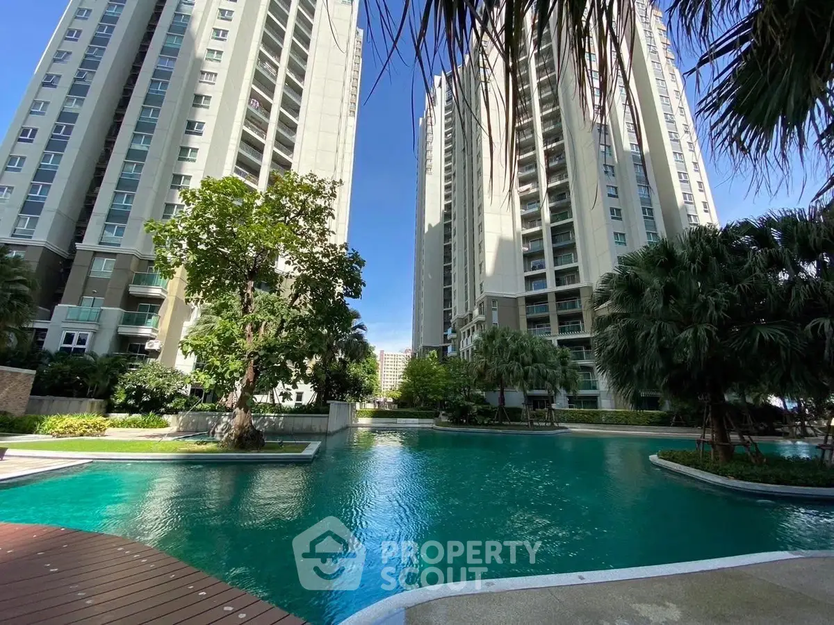 Luxurious residential complex with stunning pool and lush greenery