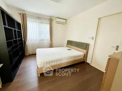Spacious bedroom with modern furnishings and natural light in a stylish apartment.