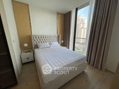 Luxurious bedroom with elegant decor and stunning city view from large window.