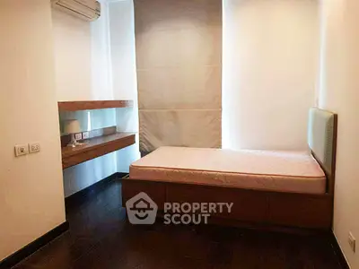 Cozy minimalist bedroom with single bed and wooden flooring