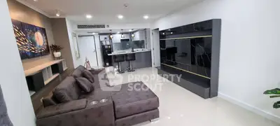 Modern living room with sleek furniture and open kitchen layout