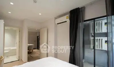 Modern bedroom with air conditioning and ensuite bathroom in a stylish apartment.
