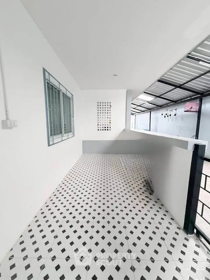 Spacious balcony with modern tiled flooring and sleek railing, perfect for relaxation and outdoor enjoyment.