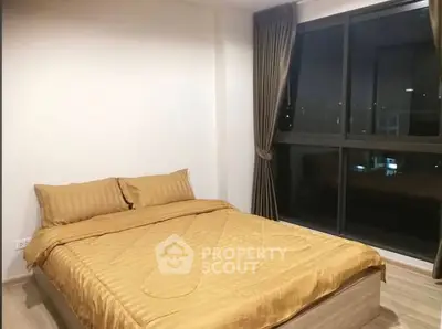 Cozy bedroom with large window and elegant curtains in modern apartment.