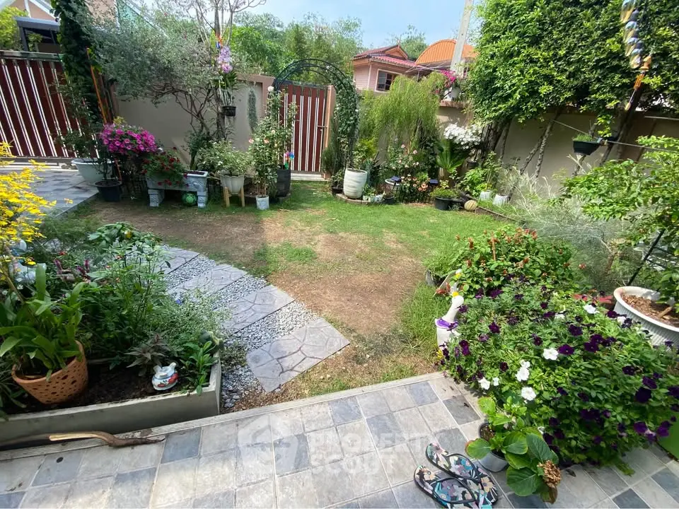 Charming garden with lush greenery and colorful flowers in a serene residential backyard.