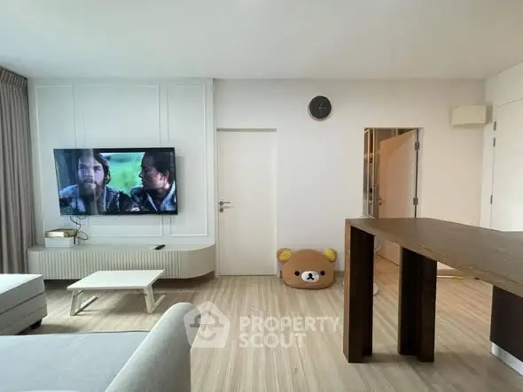 Modern living room with wall-mounted TV and stylish furniture