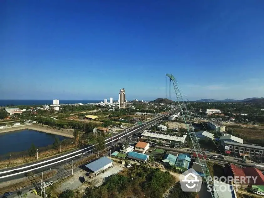 Stunning panoramic view of coastal cityscape with clear blue skies and distant ocean horizon.