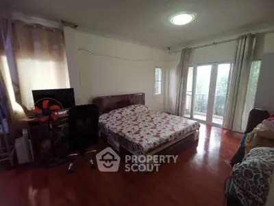 Spacious bedroom with balcony access and natural light