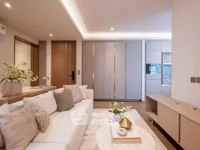 Elegant living room with modern decor and cozy ambiance, featuring a plush sofa and stylish lighting.