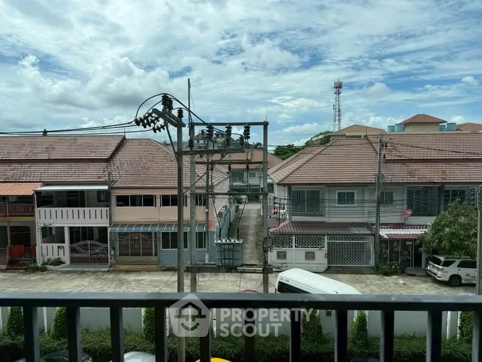 Charming suburban neighborhood view with traditional houses and clear blue sky.