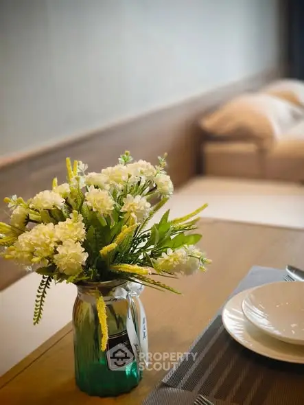 Elegant dining table setup with floral centerpiece in modern living space.