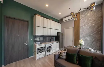 Modern apartment interior with stylish kitchen and cozy living area, featuring elegant lighting and contemporary decor.