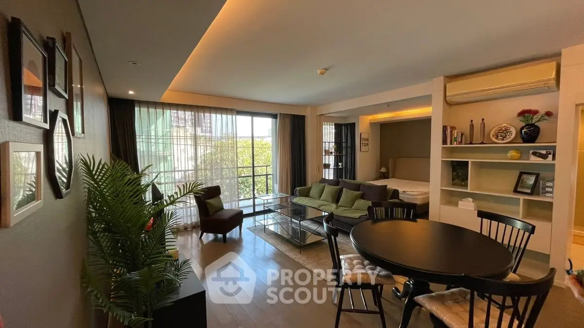 Spacious open-plan living room with modern decor and large windows.