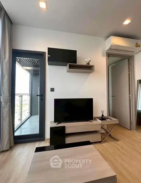 Modern living room with balcony access and sleek furniture design.