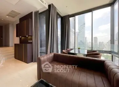 Luxurious corner unit living room with panoramic city views and elegant furnishings.