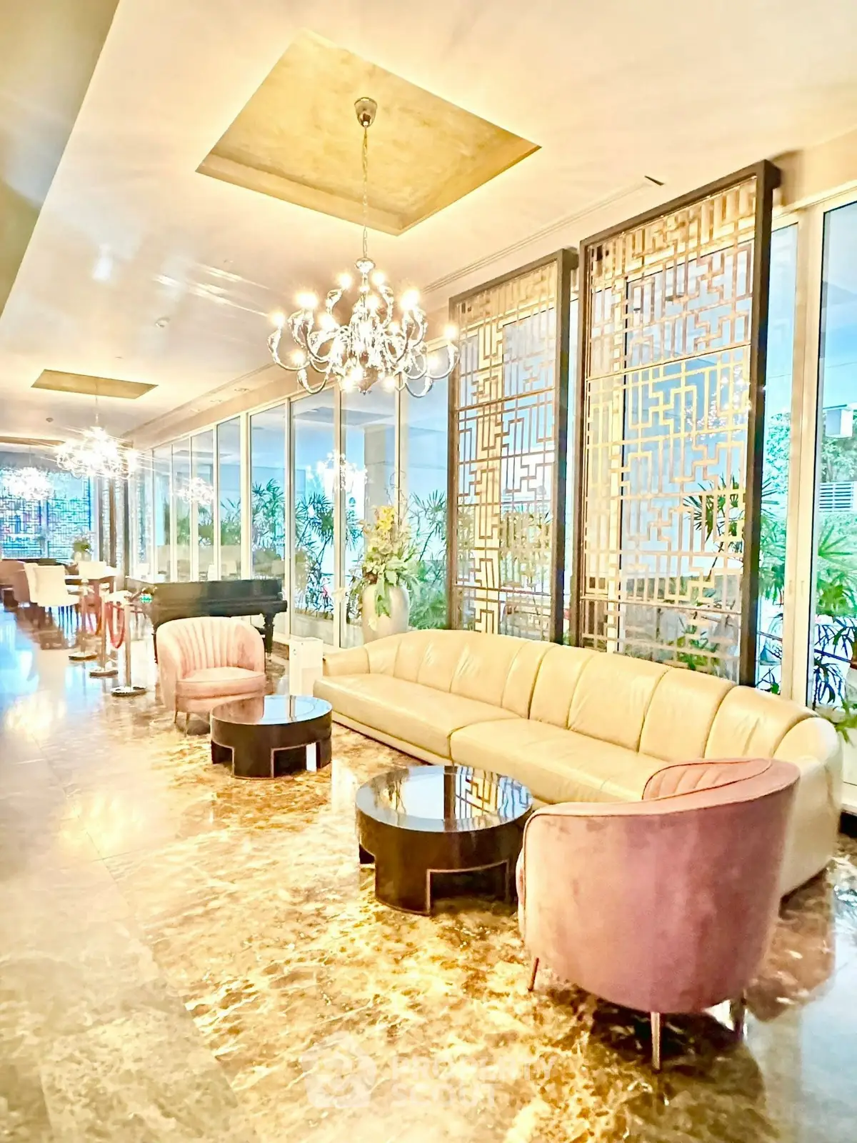 Luxurious lobby with elegant seating and chandeliers in a modern building