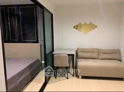 Modern studio apartment with cozy sofa and sleek glass partition