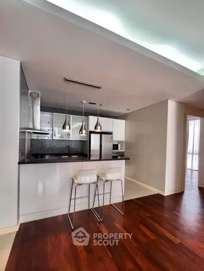 Modern kitchen with sleek design, open layout, and stylish lighting in a contemporary apartment.